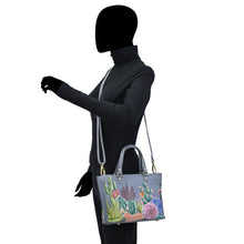 Load image into Gallery viewer, Person standing with a Anuschka Medium Tote - 693 bag over their shoulder.
