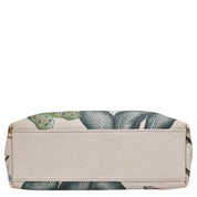 An Anuschka Medium Frame Crossbody - 700 with a leaf pattern on a white background.