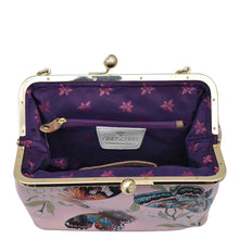 Load image into Gallery viewer, An open, hand-painted Medium Frame Crossbody - 700 clutch purse by Anuschka with vintage-inspired floral and butterfly designs, showing a purple interior with a zipped pocket.
