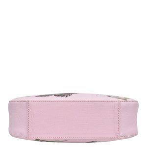 A pink floral Anuschka genuine leather cosmetic bag viewed from the side on a white background.