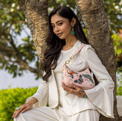 Woman posing outdoors with an Anuschka Small Convertible Hobo - 701 genuine leather shoulder bag.