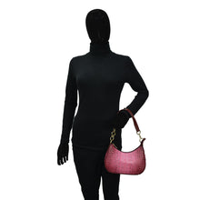 Load image into Gallery viewer, A mannequin wearing a black turtleneck and holding a pink Anuschka Small Convertible Hobo - 701 genuine leather crossbody.
