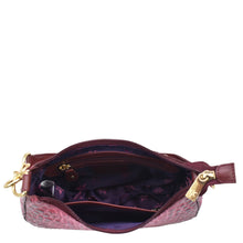 Load image into Gallery viewer, Open Anuschka Small Convertible Hobo - 701 in pink textured genuine leather with a zipper, revealing interior with items inside.
