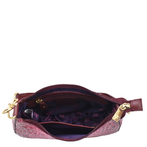 Open Anuschka Small Convertible Hobo - 701 in pink textured genuine leather with a zipper, revealing interior with items inside.