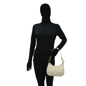 Mannequin in black attire holding a white Anuschka Small Convertible Hobo - 701.