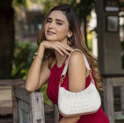A woman in a red dress posing with a white Anuschka Small Convertible Hobo - 701.