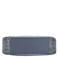 Load image into Gallery viewer, A blue genuine leather Anuschka wallet with a crocodile pattern embossed on the edges, photographed against a white background.
