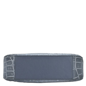A blue genuine leather Anuschka wallet with a crocodile pattern embossed on the edges, photographed against a white background.
