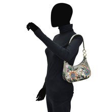 Load image into Gallery viewer, Mannequin displaying a Small Convertible Hobo - 701 floral shoulder bag with an adjustable strap by Anuschka.
