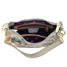 Load image into Gallery viewer, Open Anuschka Small Convertible Hobo - 701 displaying interior compartments and floral lining.
