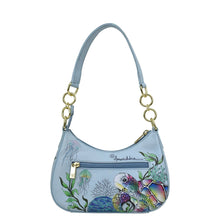 Load image into Gallery viewer, Light blue leather Small Convertible Hobo - 701 handbag featuring a colorful underwater scene with fish and aquatic plants, adorned with a gold tone hardware chain strap and an Anuschka brand tag.
