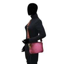 Load image into Gallery viewer, Side profile of a person with a black mannequin head wearing black attire with an Anuschka Twin Top Messenger - 704 featuring an adjustable strap.
