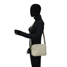 Load image into Gallery viewer, Mannequin in black attire with a masked face displaying an Anuschka Twin Top Messenger - 704 structured purse and white shoulder bag.
