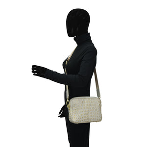 Mannequin in black attire with a masked face displaying an Anuschka Twin Top Messenger - 704 structured purse and white shoulder bag.