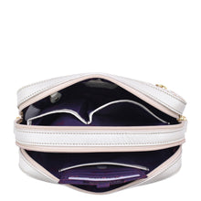 Load image into Gallery viewer, An open white Anuschka Twin Top Messenger - 704 showcasing its purple interior, compartments, and RFID protected card case.
