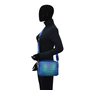 Mannequin dressed in dark clothing with a blue Twin Top Messenger - 704 featuring RFID protection by Anuschka.