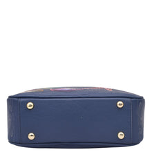 Load image into Gallery viewer, Navy blue Anuschka Twin Top Messenger - 704 with floral patterns and metal stud details, RFID protected, on a white background.
