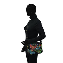 Load image into Gallery viewer, Mannequin dressed in black with a colorful, RFID protected Anuschka Twin Top Messenger - 704 shoulder bag.
