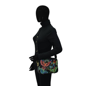 Mannequin dressed in black with a colorful, RFID protected Anuschka Twin Top Messenger - 704 shoulder bag.