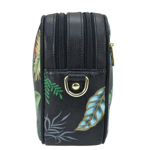 Black cylindrical cosmetic case with floral print, RFID protected, and zipper closure - Anuschka Twin Top Messenger - 704.